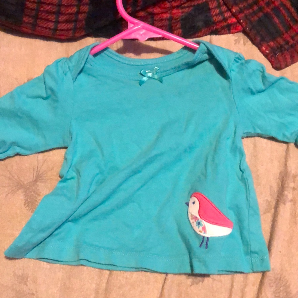 Blue shirt with a bird